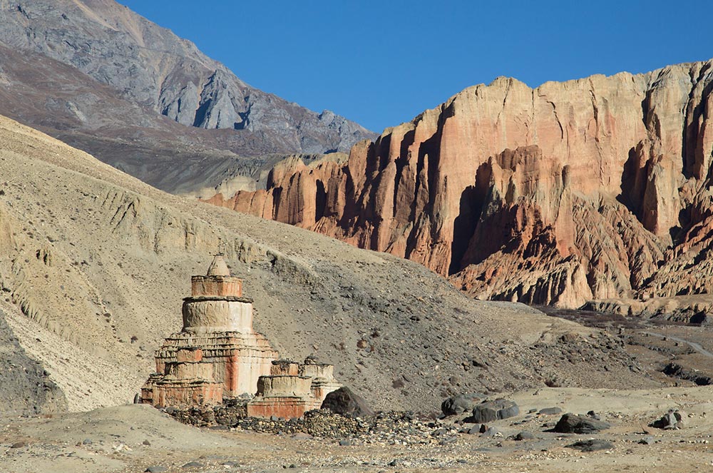 A chorten among the surreal multicolored rocks of Dhakmar, Upper Mustang.